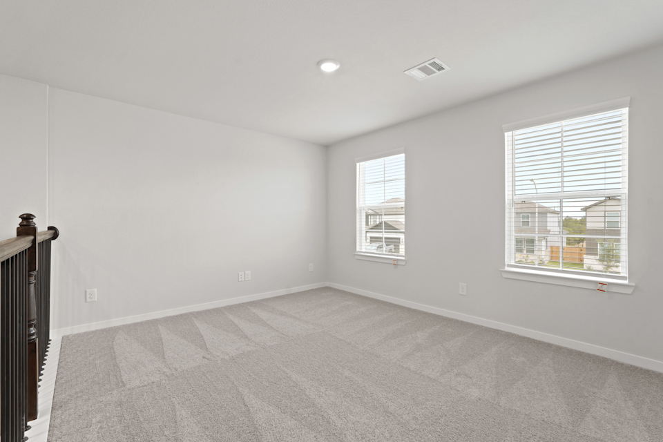 A room with windows and a carpet.