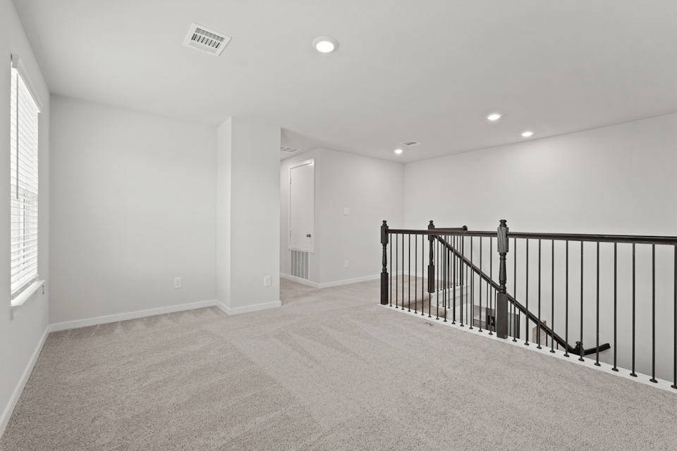 A hallway with a railing.