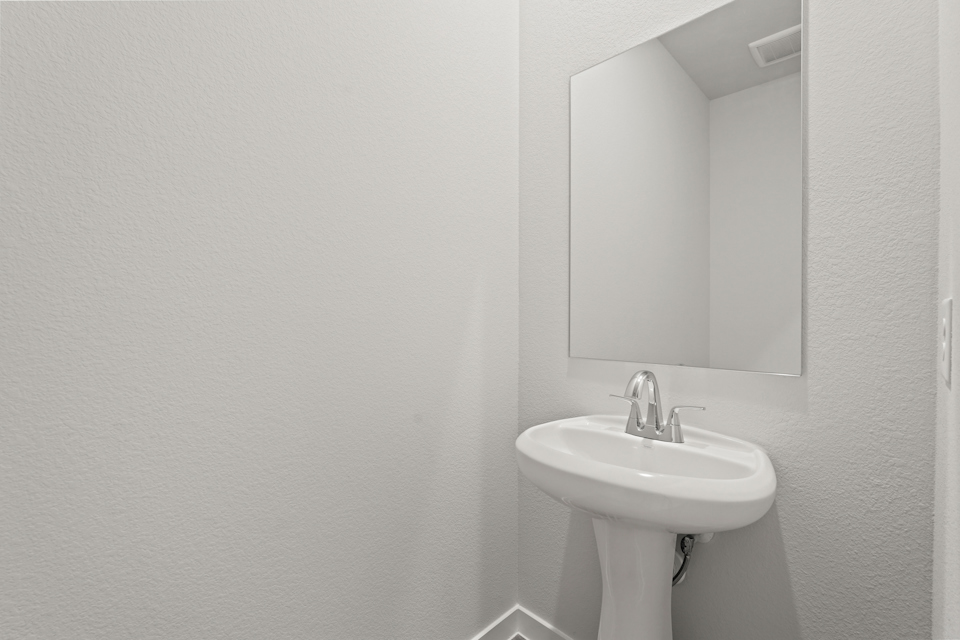 A bathroom with a mirror and sink.