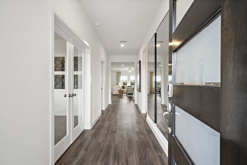 A hallway with white doors.