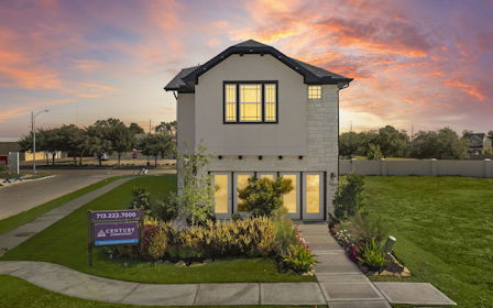 A small house with a driveway.