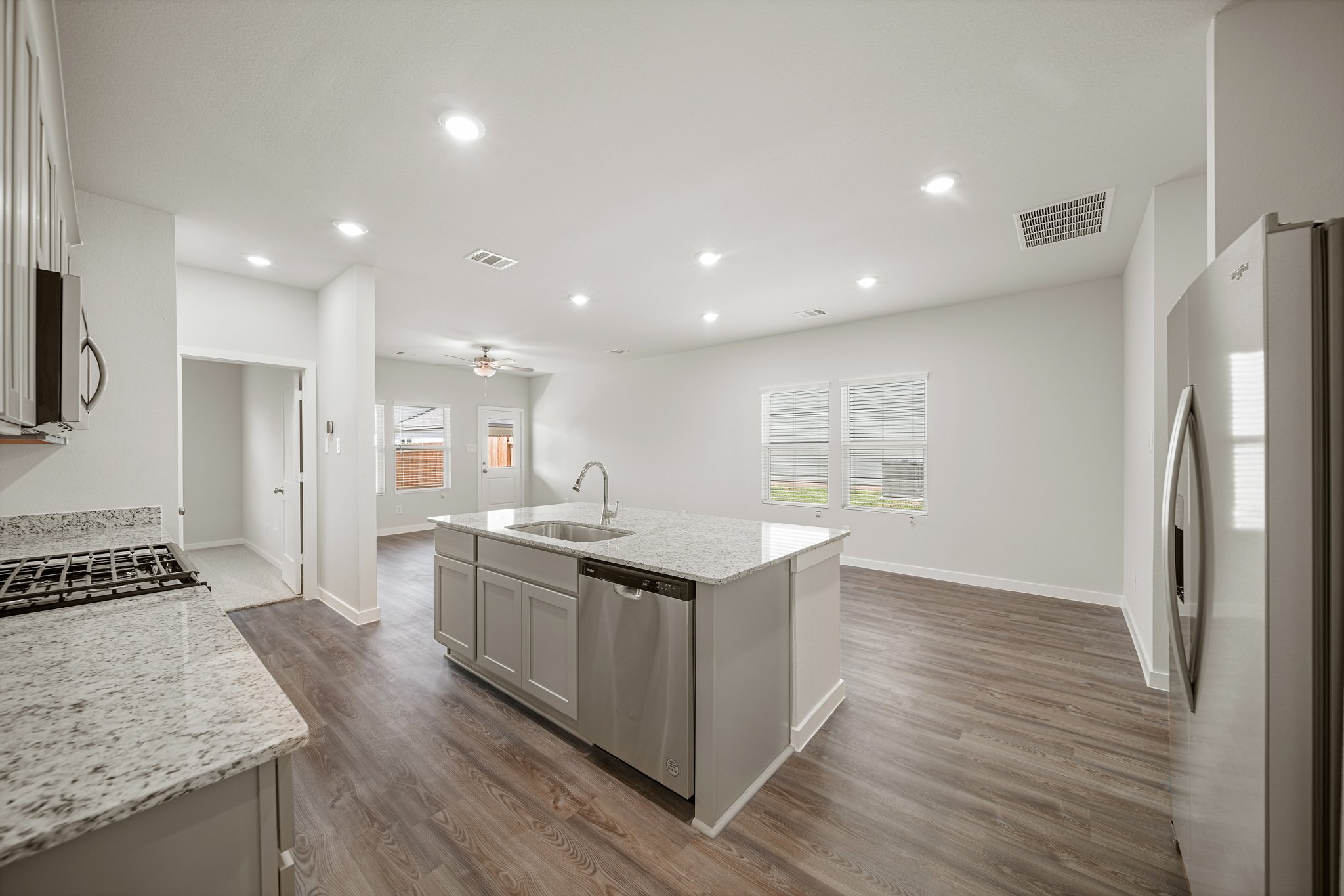 A kitchen with a marble island.