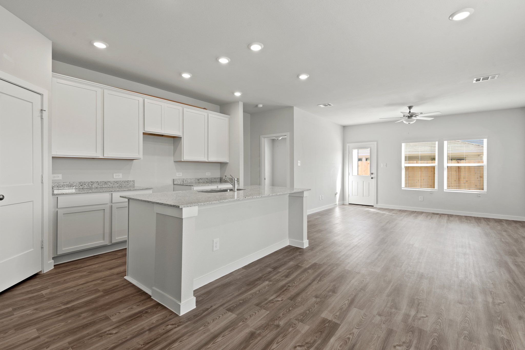 A kitchen with white cabinets.