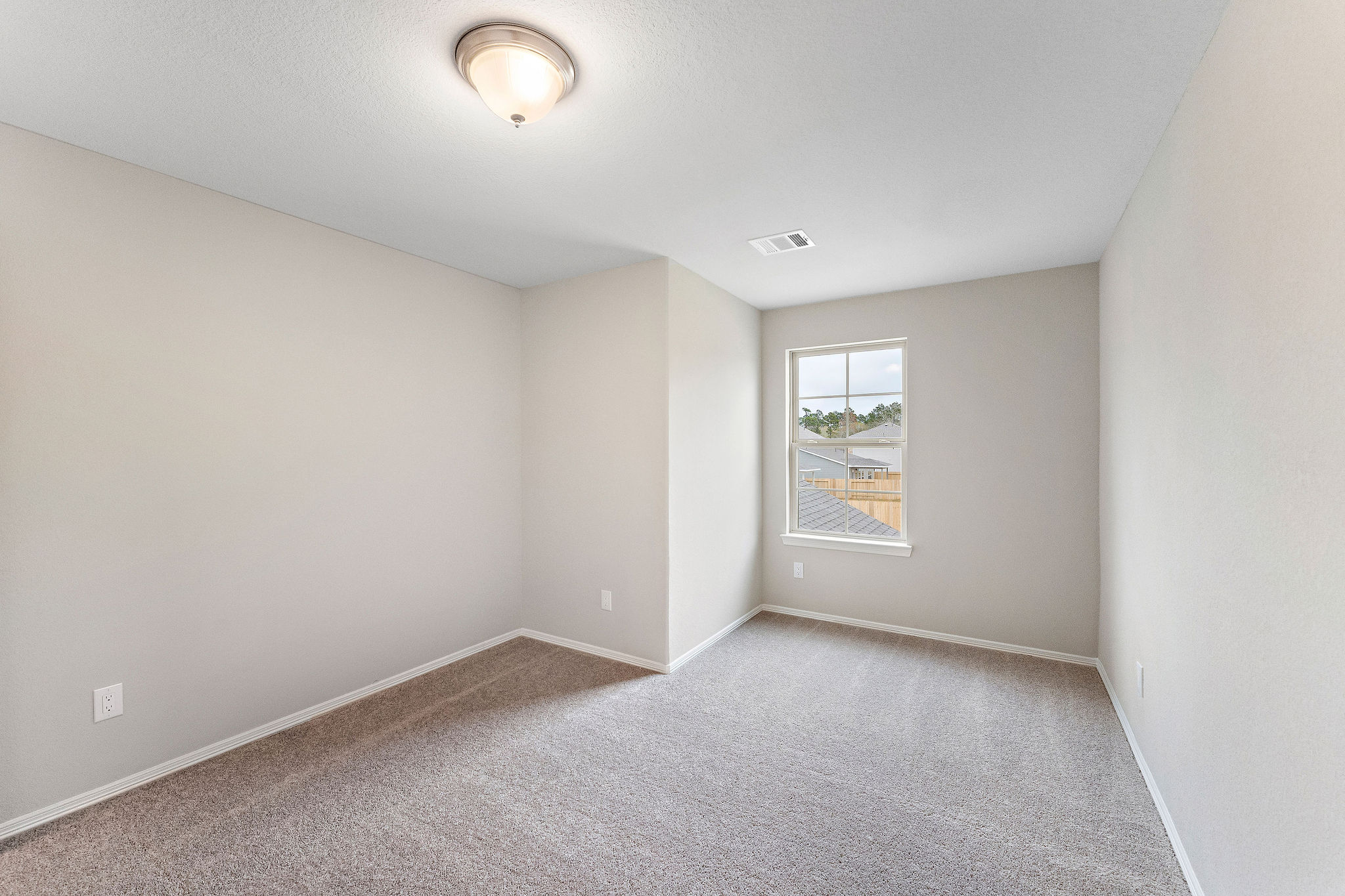 A room with a window and carpet.