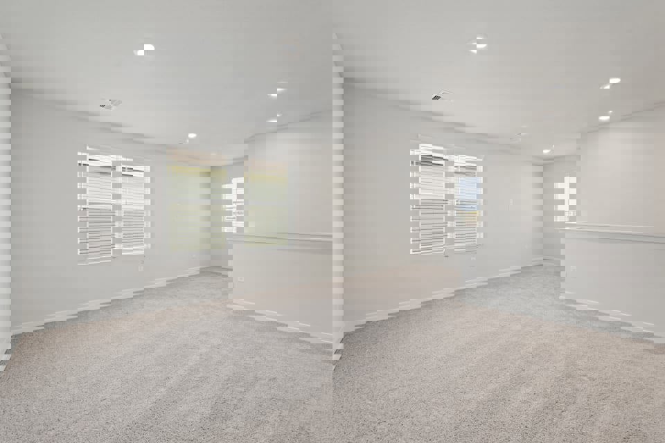 A room with white walls and windows.