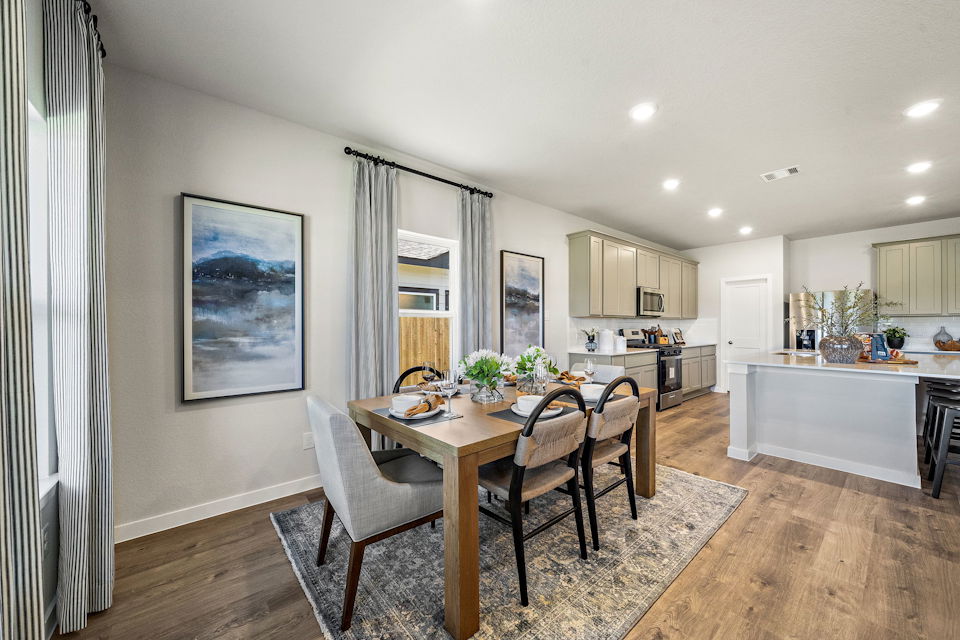 A dining room with a table and chairs.