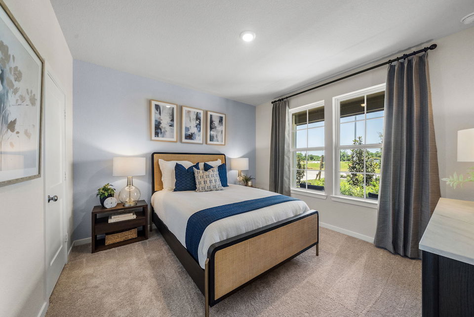 A bedroom with a bed and a window.