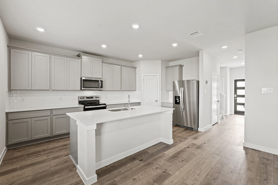 A kitchen with white cabinets.