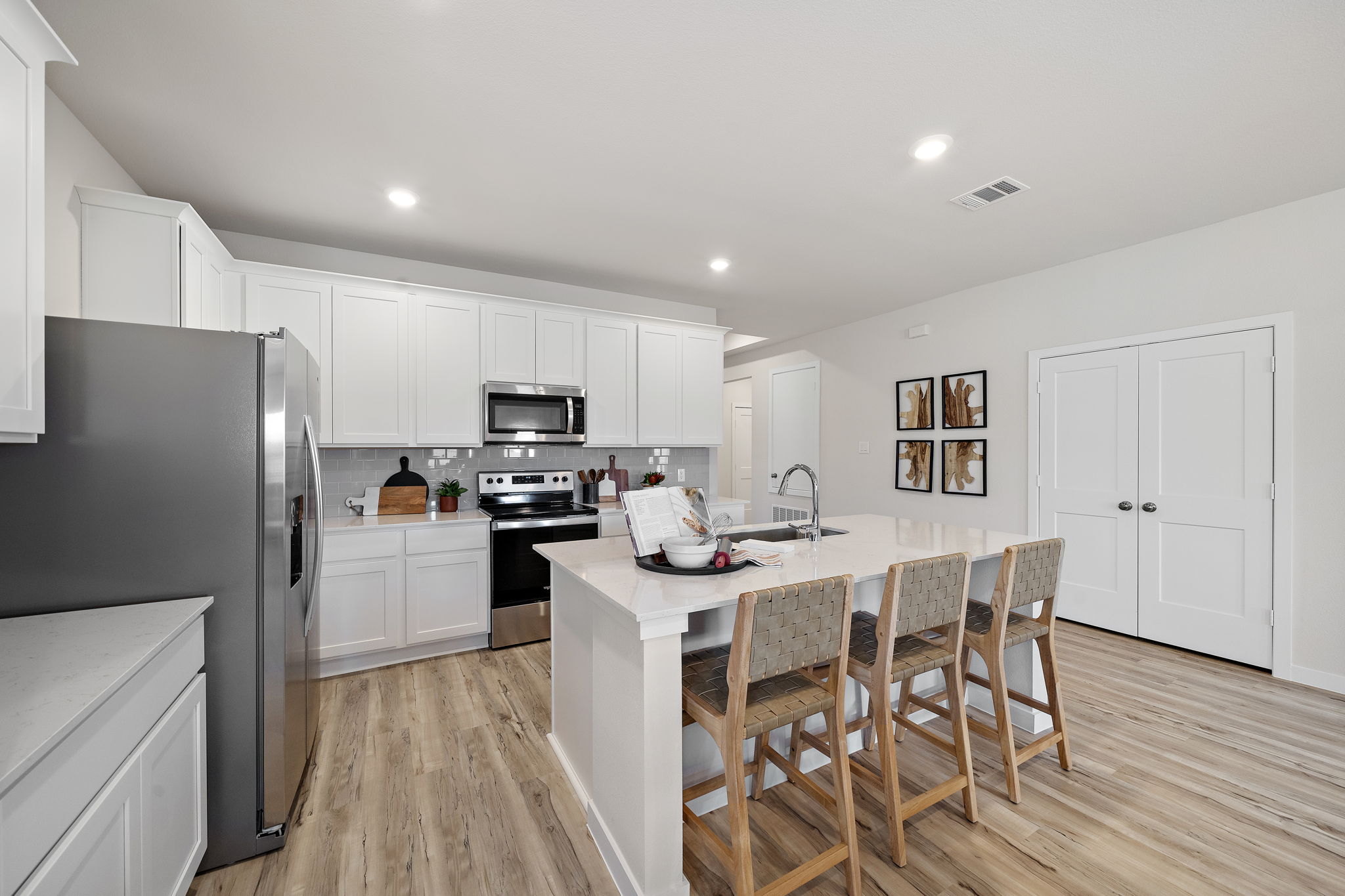 A kitchen with white cabinets.