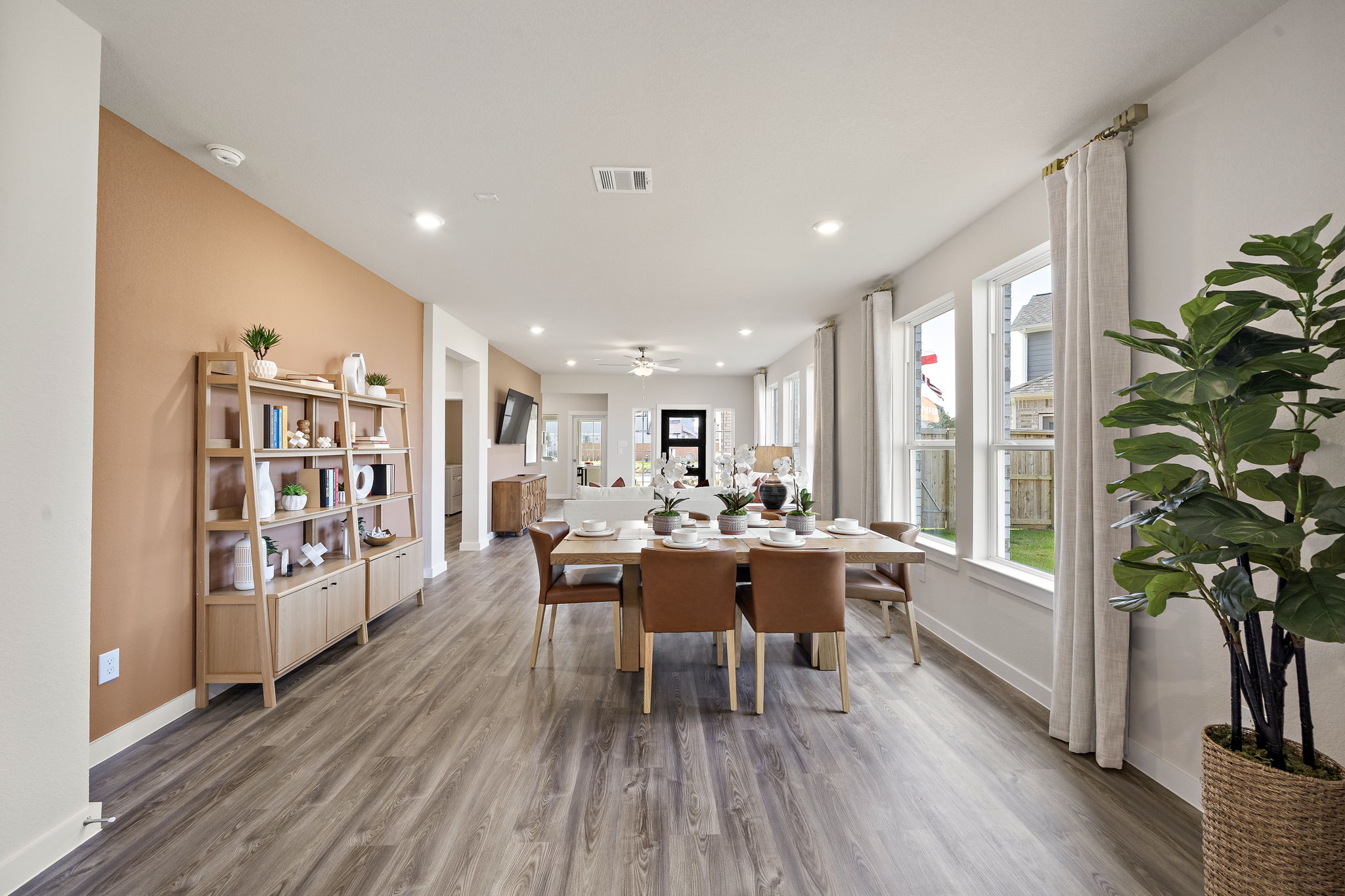 A dining room with a table and chairs.