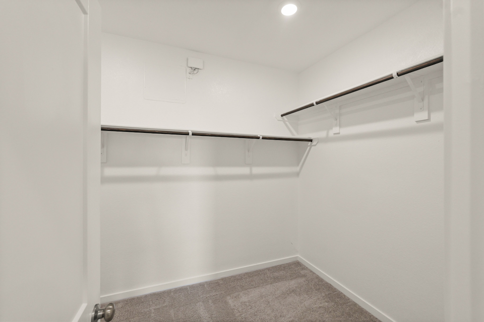 A white wall with a metal bar.