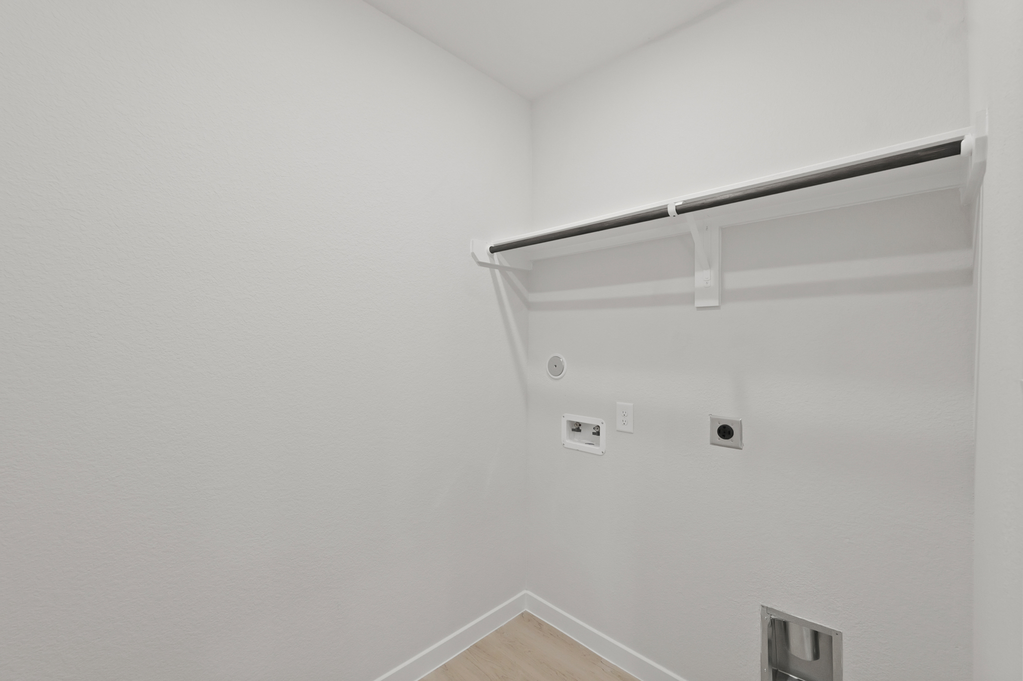 A white wall with a light fixture.