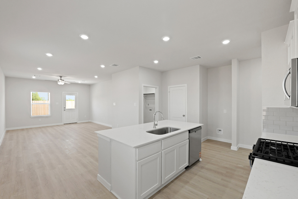 A large kitchen with white cabinets.