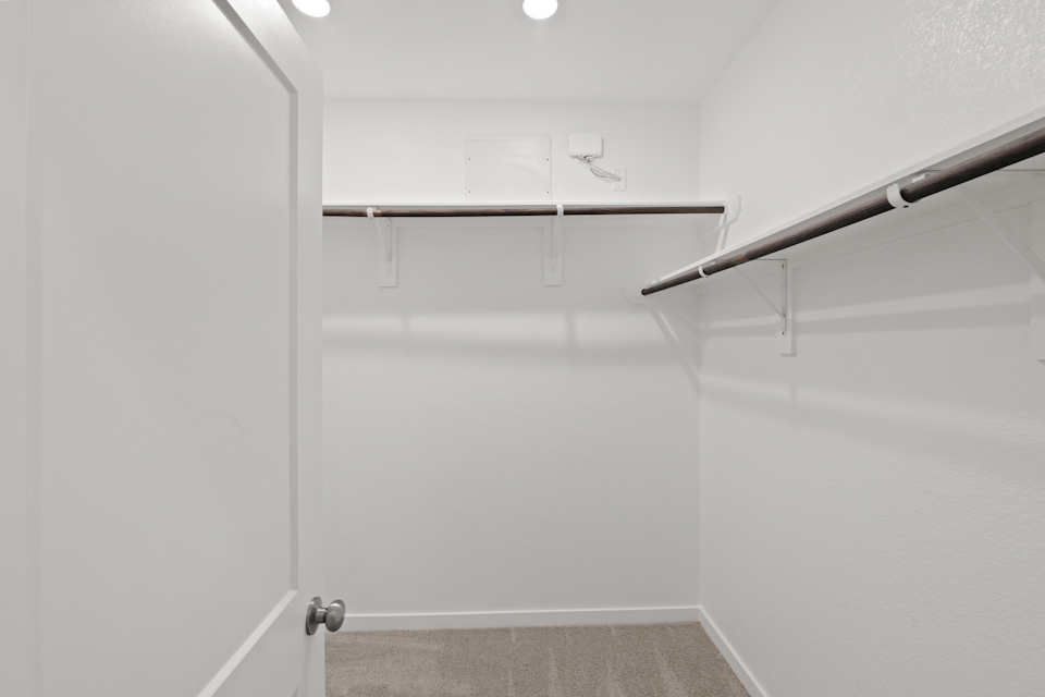 A white wall with a metal bar.