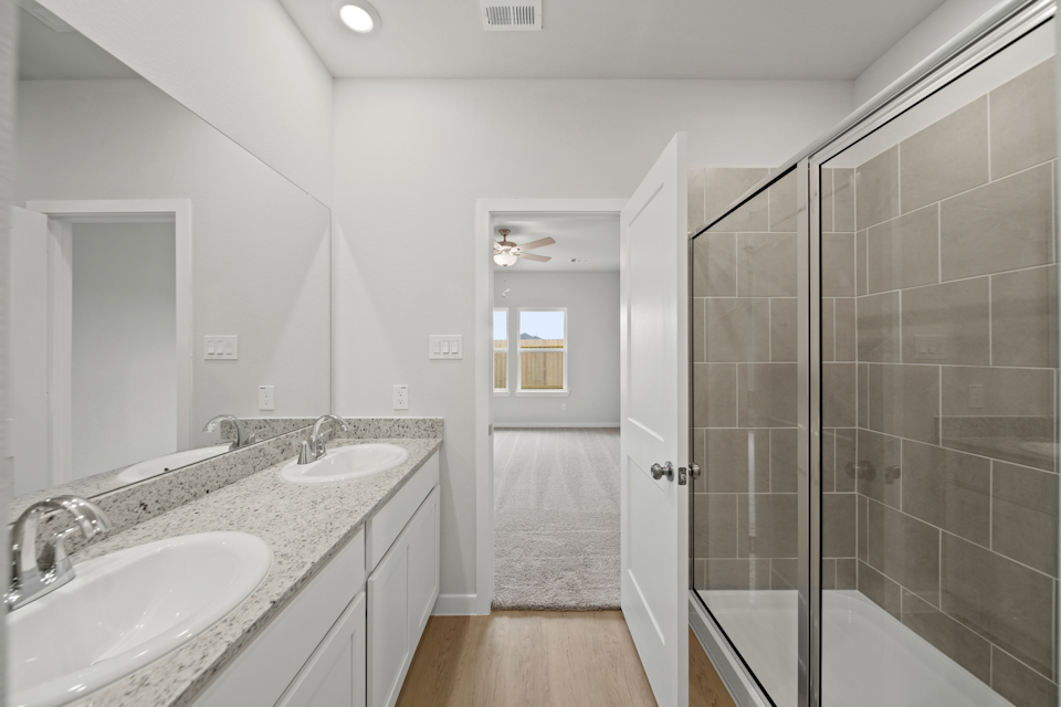 A bathroom with a sink and a shower.