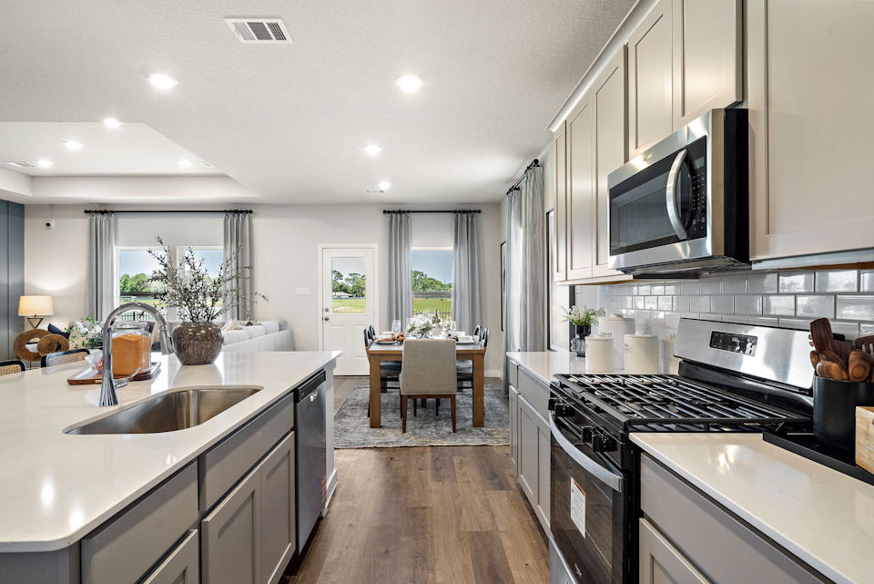 A kitchen with a table and chairs.