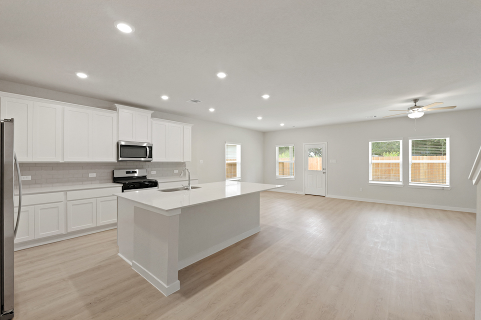 A kitchen with white cabinets.