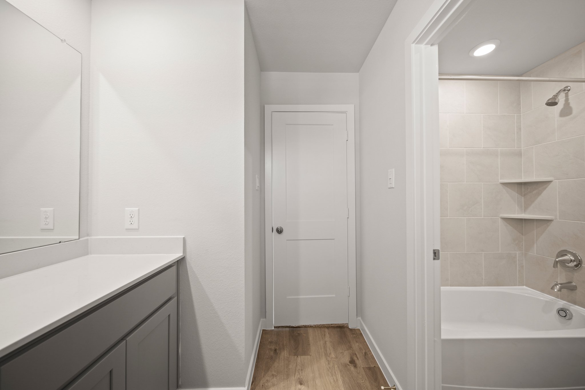 A bathroom with a tub and sink.