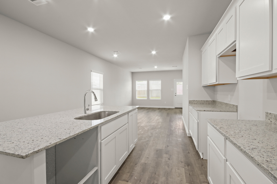 A kitchen with white cabinets.