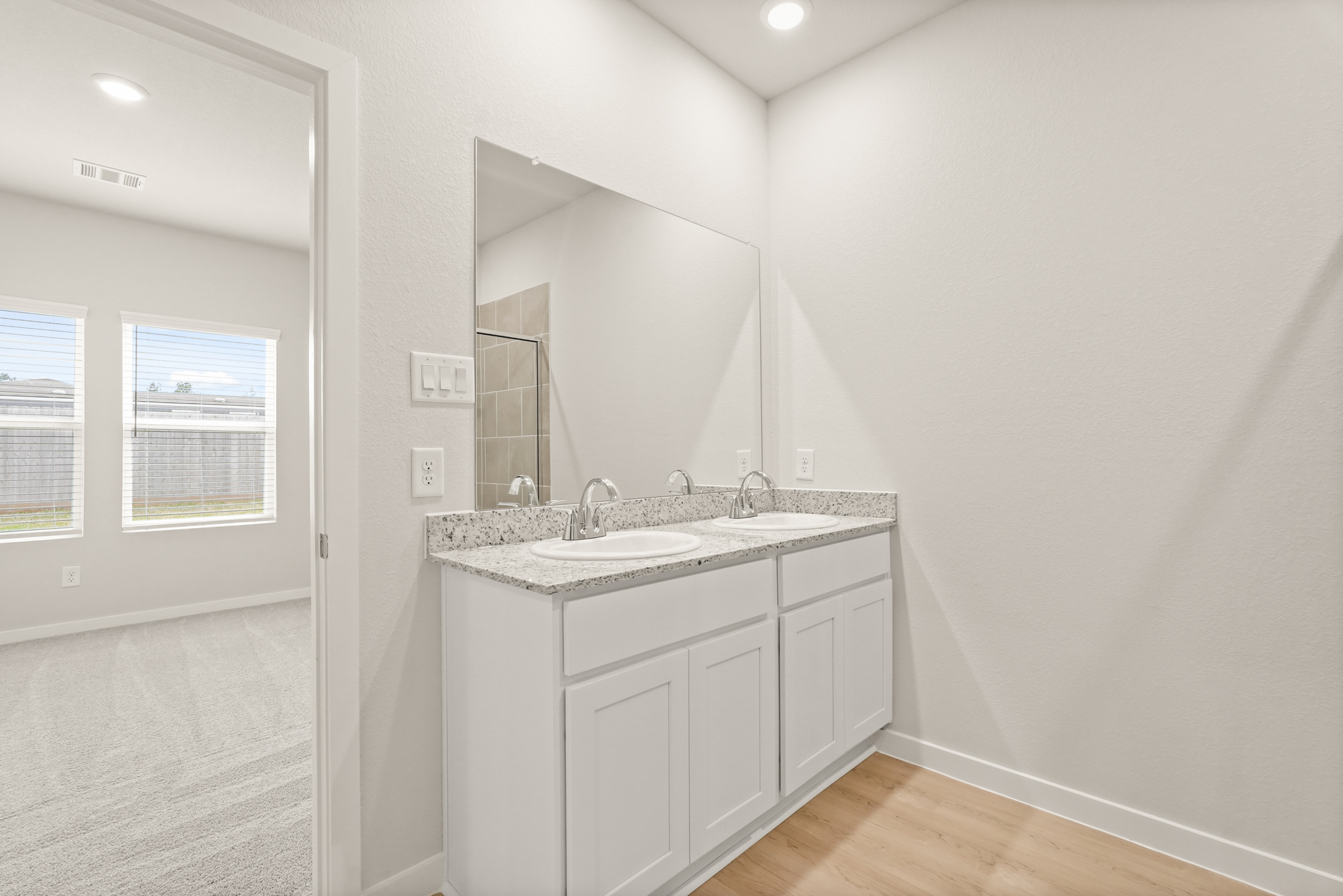 A bathroom with a sink and a mirror.