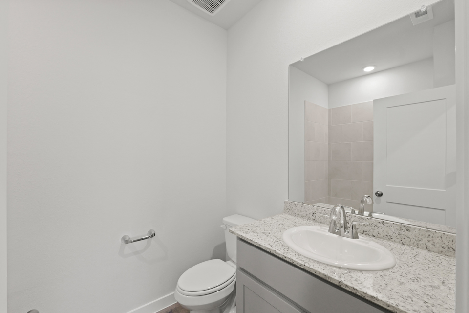 A bathroom with a marble countertop.