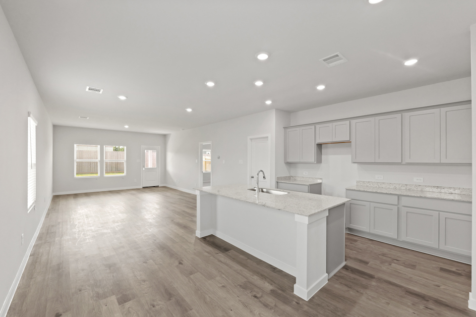A kitchen with white cabinets.