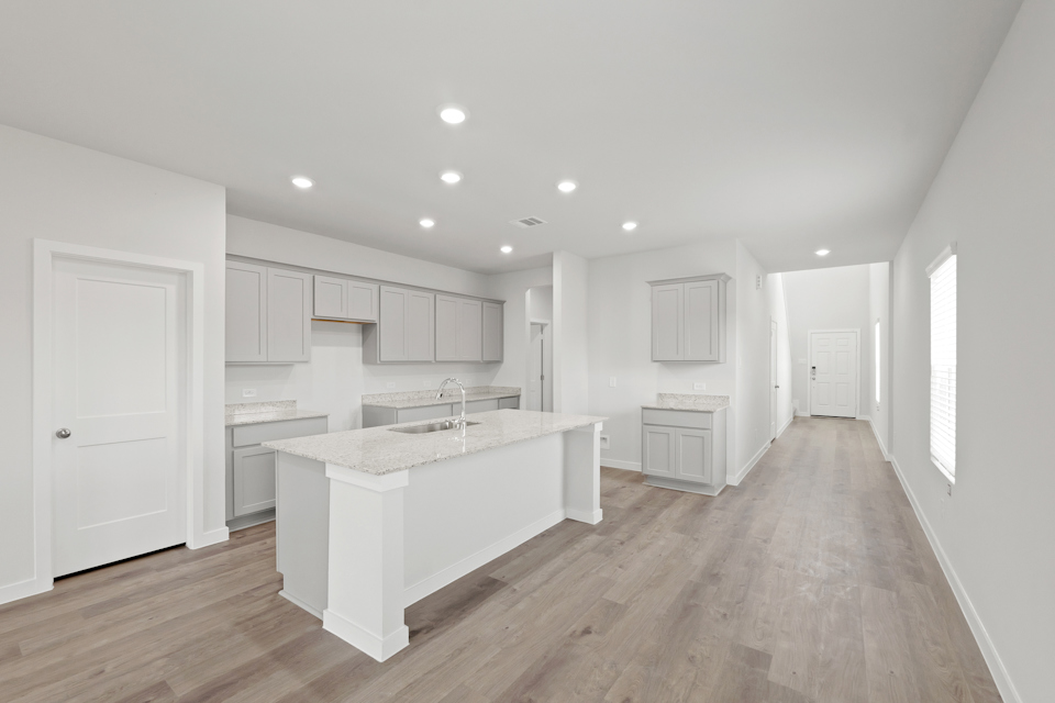 A large kitchen with white cabinets.