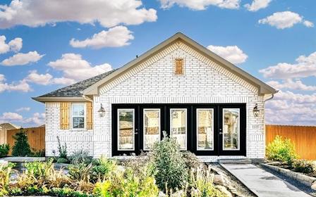A house with a fence and bushes.