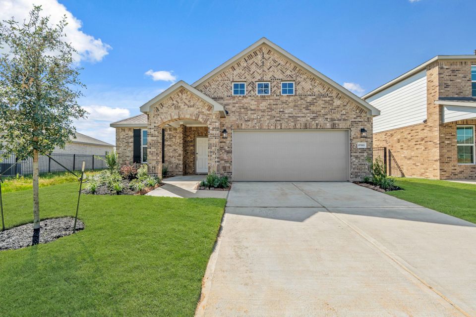 A large brick house with a driveway.