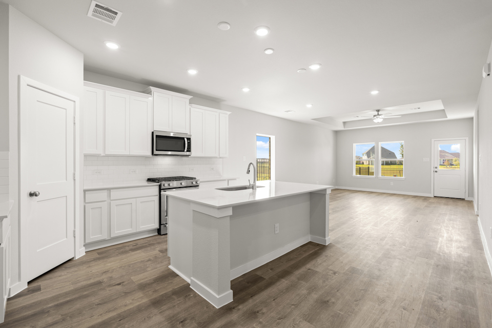 A kitchen with white cabinets.