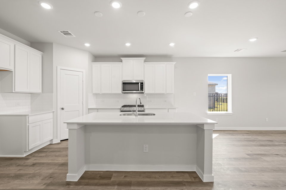 A kitchen with white cabinets.