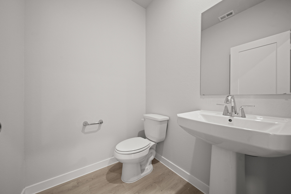 A bathroom with a toilet and sink.