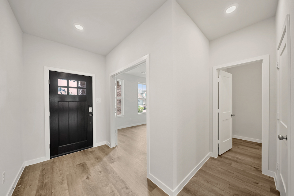 A room with white walls and black doors.
