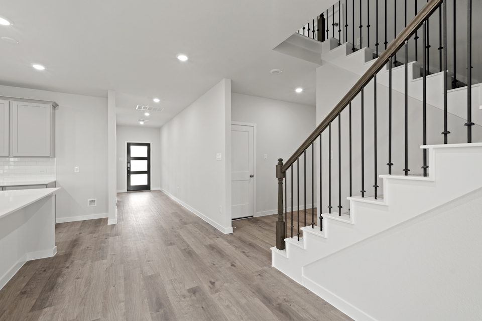 A large white room with a wood floor and white walls.