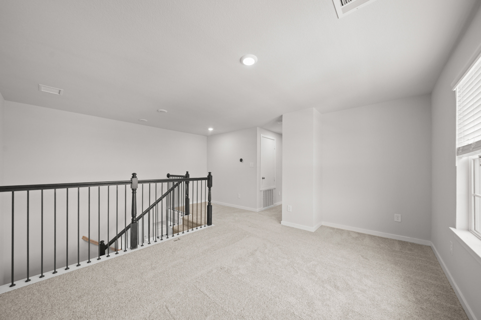 A hallway with a railing.