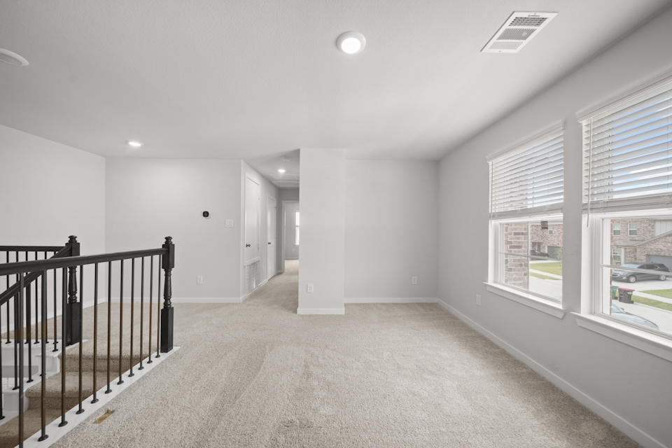 A large empty room with a railing.