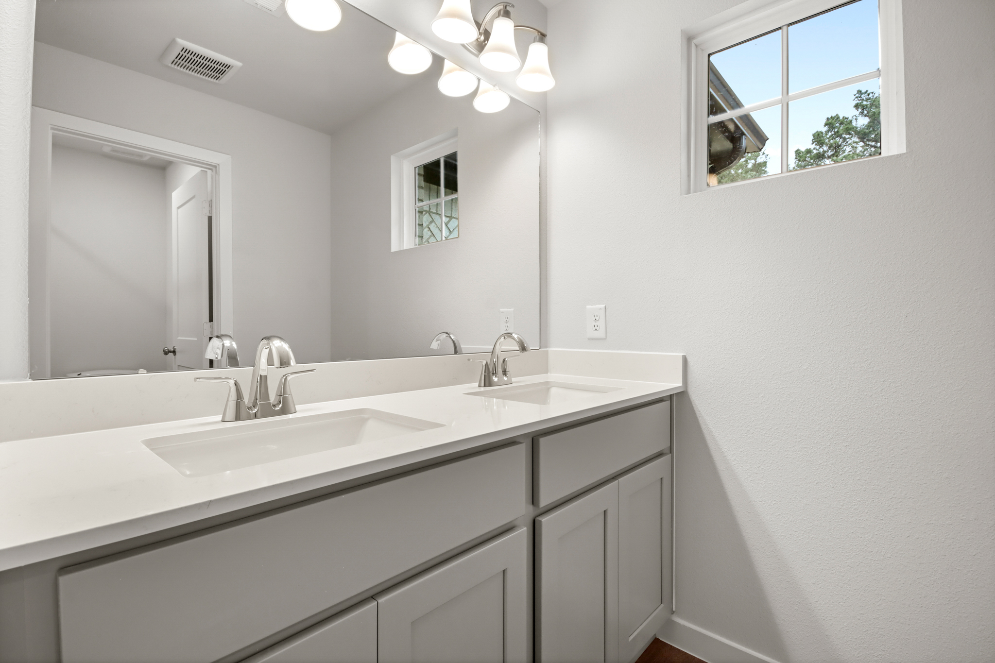 A bathroom with a large mirror.