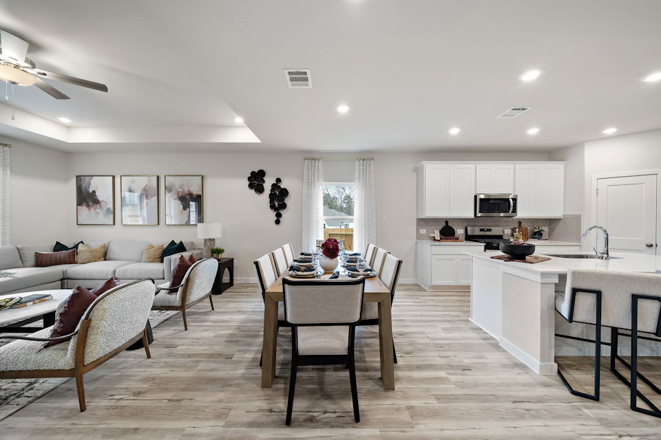 A large kitchen with a dining table.