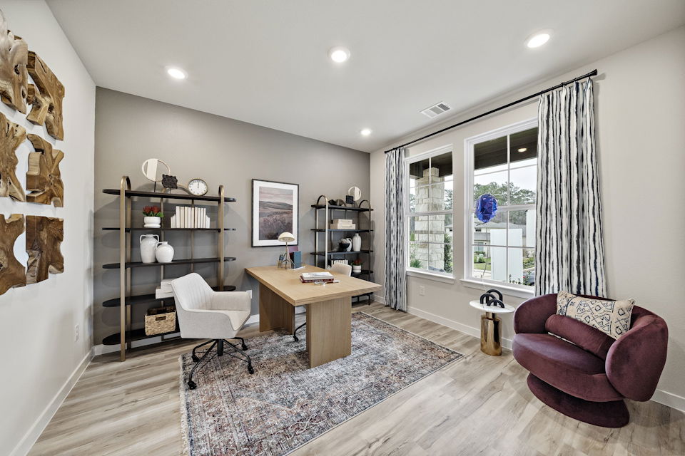 A living room with a table and chairs.
