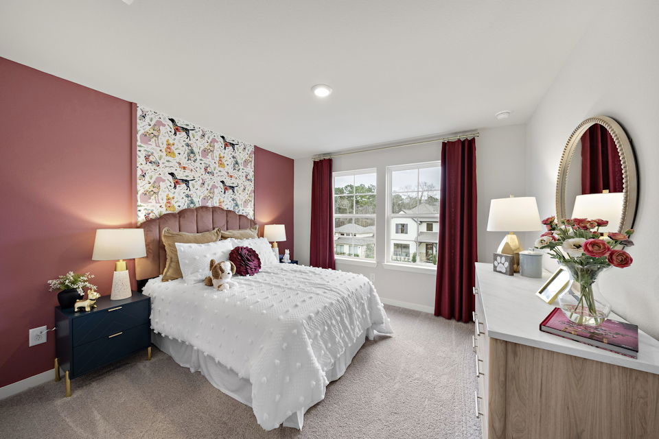 A bedroom with pink walls.