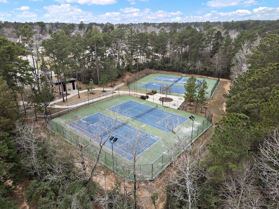 A swimming pool surrounded by trees.
