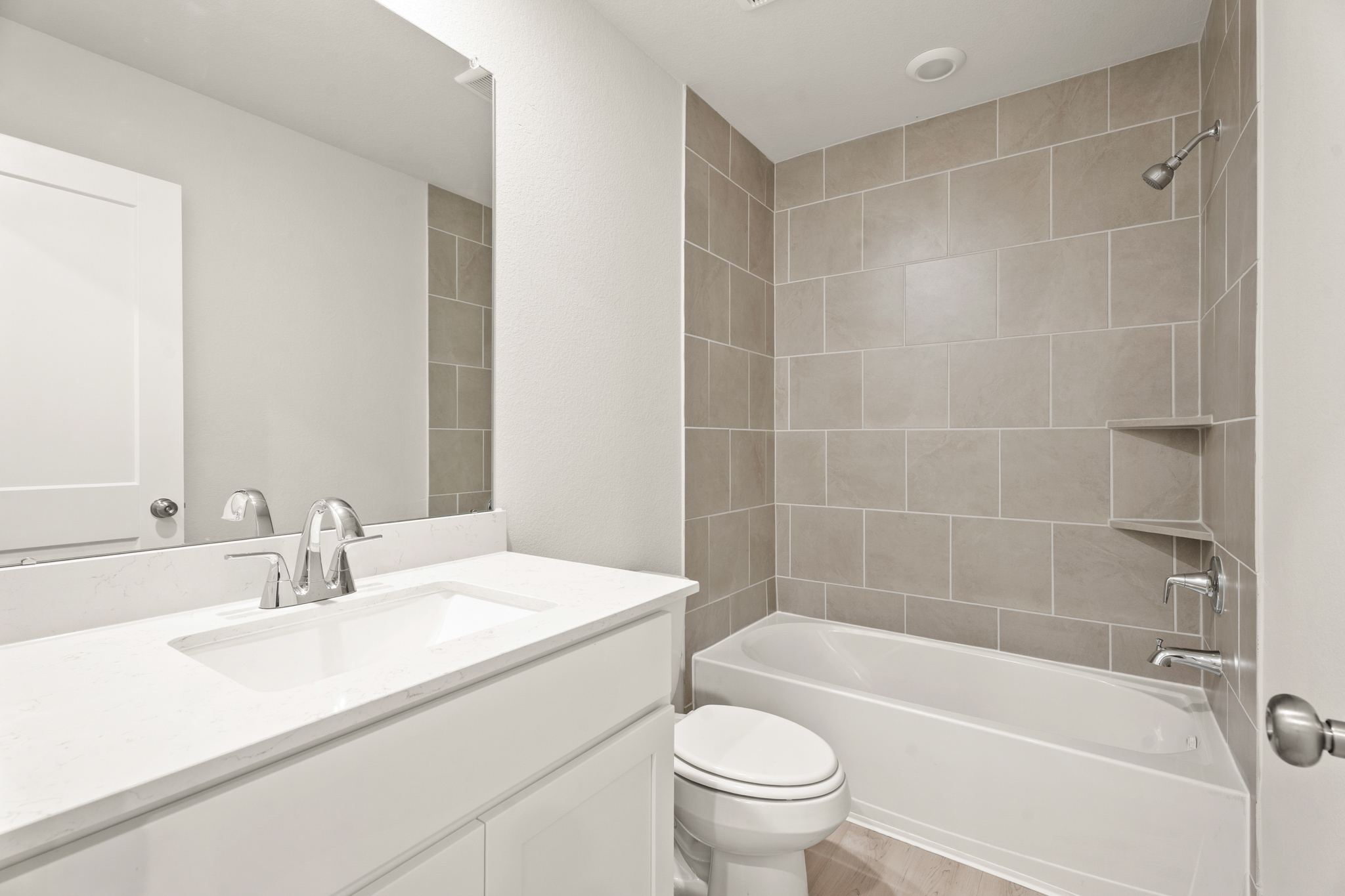 A bathroom with a tub sink and toilet.