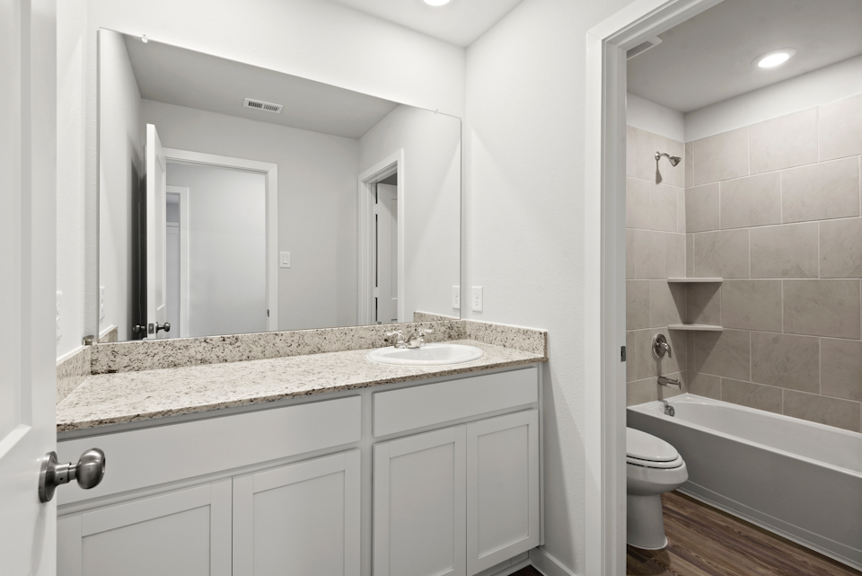 A bathroom with a marble countertop.