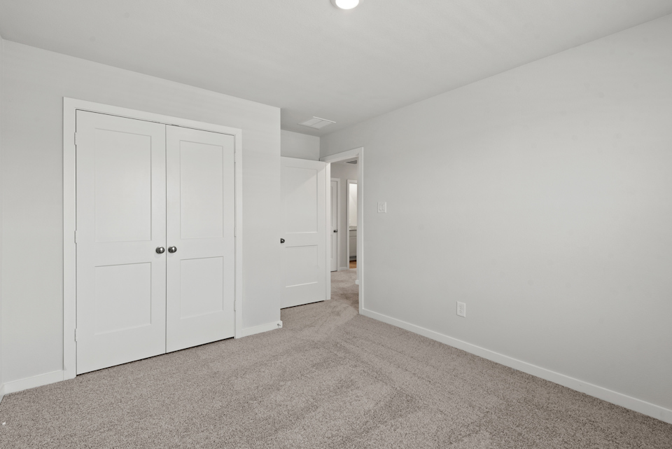 A hallway with white doors.