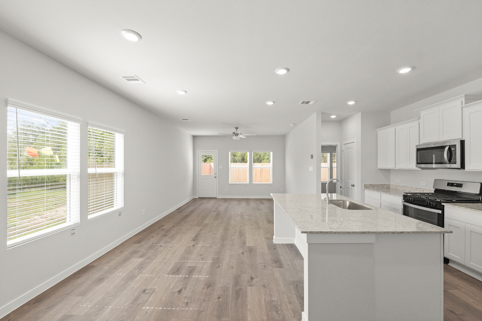 A kitchen with white cabinets.