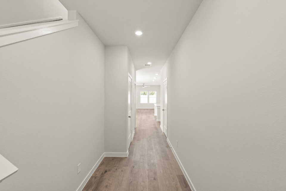 A hallway with white walls.