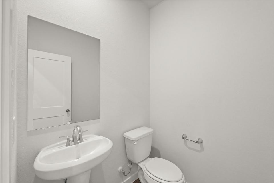 A bathroom with a toilet and sink.