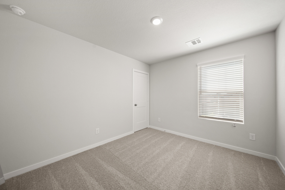 A room with a door and a window.