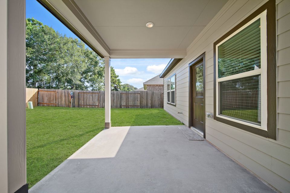 A house with a fence and grass.