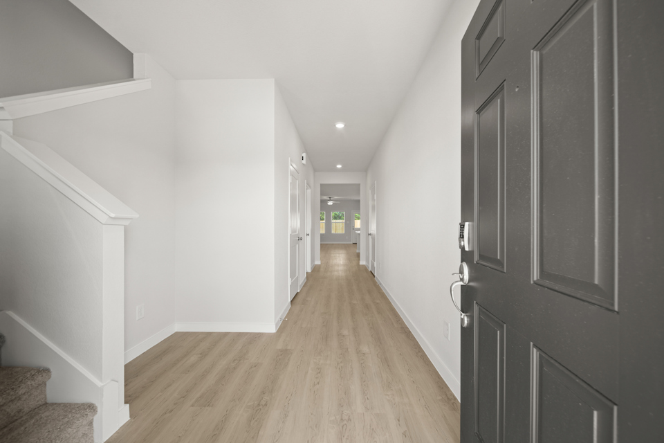 A hallway with white walls.